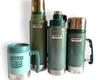 Three Green Stanley Vacuum Bottles and One Stanley Mug