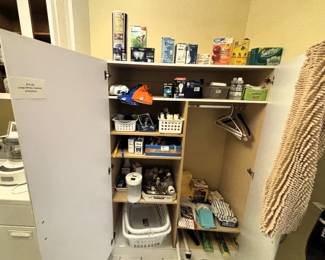 Large cabinet with shelves, cleaning products.