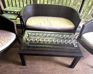 Wicker chairs, loveseat with cushions. Metal coffee table.