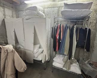 Clothes racks, covered racks and clean pillows.