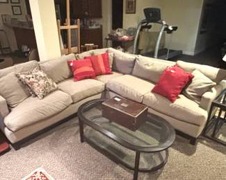 Beige sectional, coffee table and end table.