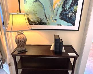 Three shelf side table, lamp and wall art.