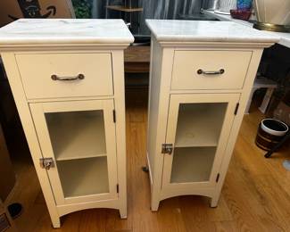 Beautiful matching pair of cream-white wooden nightstands featuring elegant genuine marble tops. Perfect as bedroom nightstands, bathroom storage, or living room end tables.