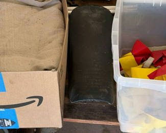 Lot 22: Assorted household items: box, curved plastic component with latch, bin of red and yellow straps, and towel