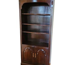 Lot #161 - Vintage Ethan Allen Georgian Court Cherry Bookcase with Brass Handles and Cabinet Storage