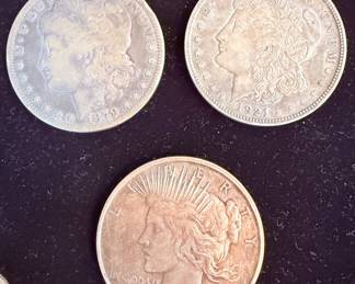 Morgan silver dollars and a peace dollar 