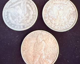 Morgan silver dollars and a peace dollar