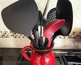 Red Ceramic Crock with Assorted Black and Red Utensils