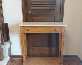 Stone Topped Entry Table With Wood Detailing With Brass Knobs