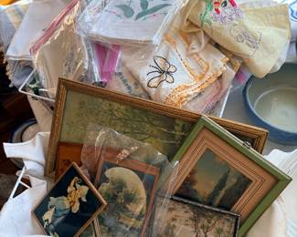 Piles of dinnerwear, linens, placemats, napkins rings, dishes etc