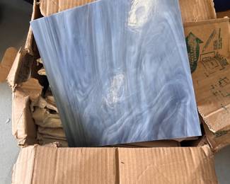 many pieces of slag glass and stained glass for windows