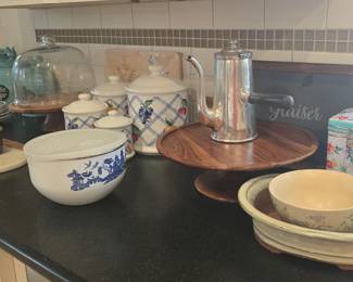 canisters, cake plate, mortar & pestle, cutting board, and a variety of dishes