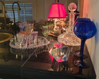 Decanter, shot glasses and other colorful glassware