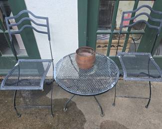 2 metal chairs and a table