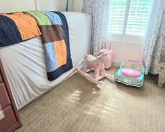spare twin mattress displaying one comforter/sham (set of 2), kids rocking horse and lots more toys!