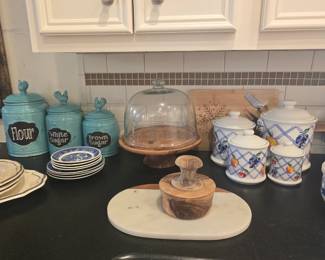 canisters, cake plate, mortar & pestle, cutting board, and a variety of dishes