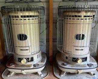(2) Corona 23-DK Kerosene Heaters & 5 Gallon Kerosene Cans Pair of Corona 23-DK kerosene heaters plus plastic 5-gallon kerosene fuel cans. Portable indoor/outdoor supplemental heat setup great for workshop, garage, hunting camp or emergency backup use.  Items show normal use, dust, surface rust, discoloration & storage wear. Fuel levels unknown. Untested. Buyers should inspect & service prior to use.  See photos for condition, included items & details. 