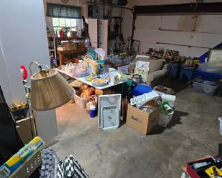 This garage is packed and there is also a shed full of yard decor and toold