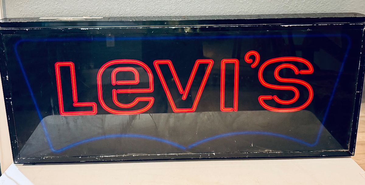 vintage Levi's neon store display sign, featuring red lettering for the brand name and a blue neon outline.
