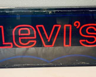 vintage Levi's neon store display sign, featuring red lettering for the brand name and a blue neon outline.