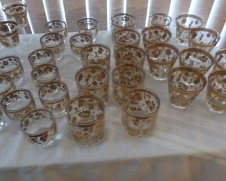 assorted sizes of gold trimmed glasses