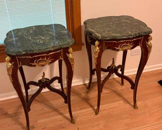 Ornate end tables with gold detail and marble tops