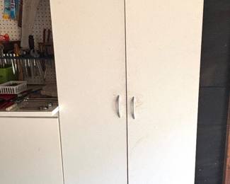 Several garage storage white cabinets