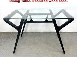 Lot 220 Italian Modernist style Glass Top Dining Table. Ebonized wood base. 
