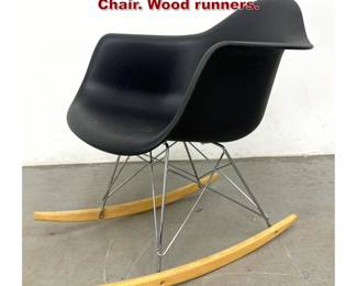 Lot 496 Eames Style Plastic Shell Rocking Chair. Wood runners.
