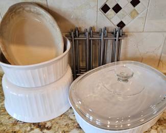 Lot # B67 - CorningWare White Ceramic Baking Dishes with Glass Lid, French Baking Dish, and 4 Metal Trivets