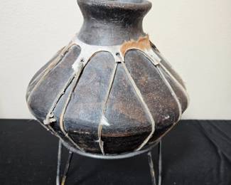 This is a vintage Tarahumara Indian olla pot crafted from terra cotta and bound with rawhide for structural support.
