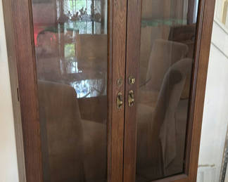 Lot 321: Dark wood gun cabinet with glass doors