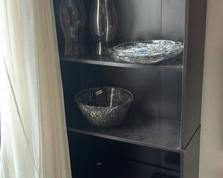 Lot 283: Tall black bookshelf with glassware