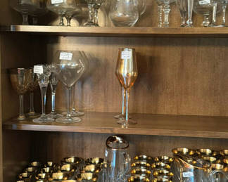 Lot 316: Assorted glassware: champagne flutes, wine glasses, goblets, and a crystal pitcher