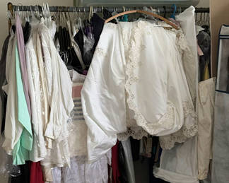 Lot 99: White bridal gowns and formal wear on hangers
