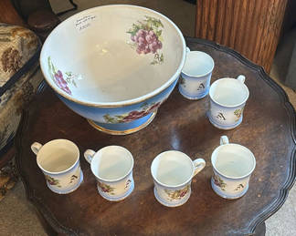 Lot 262: Grapevine-pattern porcelain punch bowl with matching mugs