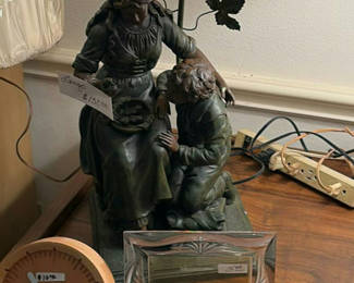 Lot 74: Bronze-toned figurine sculpture, round clock, glass frame, and jewelry box