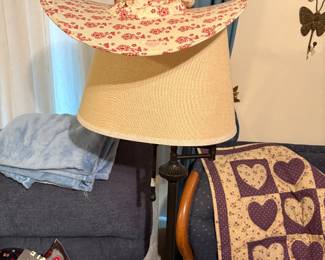 Large lamp at end of sofa with hat on top