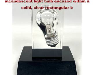 Lot 766 Pop Art Bulb Sculpture. Standard incandescent light bulb encased within a solid, clear rectangular b