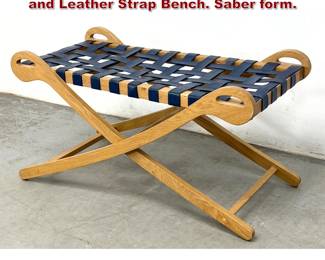 Lot 972 MidCentury Campaign Style Oak and Leather Strap Bench. Saber form. 