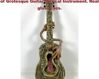 Lot 664 Gary A. Rothera Fantasy Sculpture of Grotesque Guitar Musical Instrument. Real glass eyes.