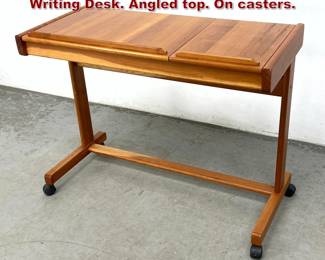 Lot 947 Mid Century Modern Teak Sofa Writing Desk. Angled top. On casters. 