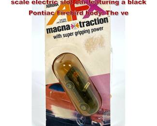 Lot 1586 Aurora AFX MagnaTraction HO scale electric slot car featuring a black Pontiac Firebird body. The ve