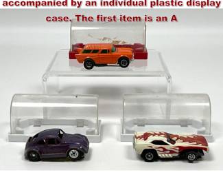 Lot 1591 3 HO scale slot cars, each accompanied by an individual plastic display case. The first item is an A