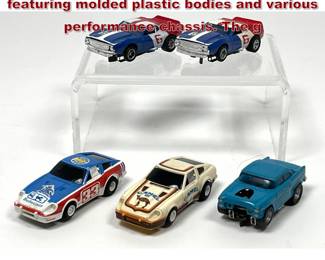 Lot 1571 5 HO scale electric slot cars featuring molded plastic bodies and various performance chassis. The g