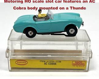 Lot 1600 Aurora Plastics Corp. Model Motoring HO scale slot car features an AC Cobra body mounted on a Thunde