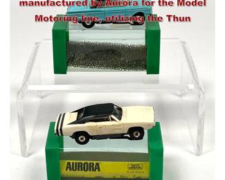 Lot 1594 2 HO scale electric slot cars manufactured by Aurora for the Model Motoring line, utilizing the Thun