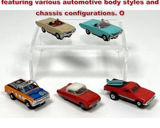 Lot 1566 5 HO scale electric slot cars featuring various automotive body styles and chassis configurations. O