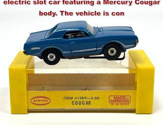 Lot 1599 Aurora Model Motoring HO scale electric slot car featuring a Mercury Cougar body. The vehicle is con