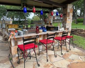 In the back yard you will find lots of floral, planters, candle holders, these metal bar chairs and lots more!